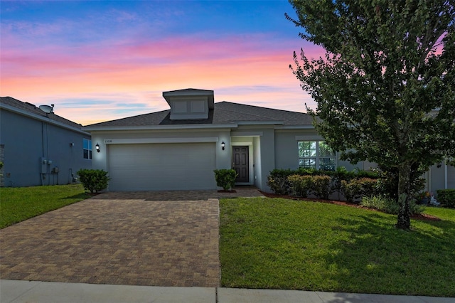 1504 Finchburg St, Minneola, FL 34715 - ranch-style home with a garage, a front yard, decorative driveway, and stucco siding