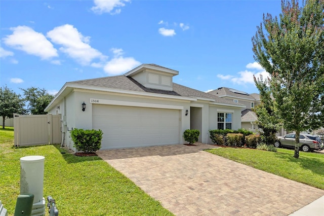 1504 Finchburg St, Minneola, FL 34715 - view of front of home featuring decorative driveway, a garage, roof with shingles, and stucco siding