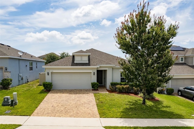 1504 Finchburg St, Minneola, FL 34715 - view of front of home with roof with shingles, an attached garage, driveway, a front lawn, and stucco siding