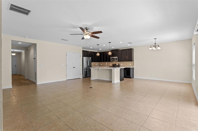 1504 Finchburg St, Minneola, FL 34715 - unfurnished living room with light tile patterned flooring, a chandelier, a ceiling fan, and recessed lighting