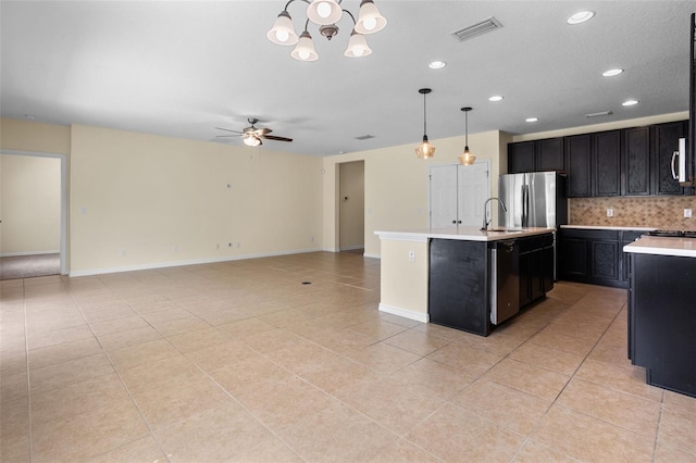 1504 Finchburg St, Minneola, FL 34715 - kitchen featuring light countertops, dark cabinets, tasteful backsplash, light tile patterned flooring, and recessed lighting