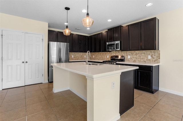 1504 Finchburg St, Minneola, FL 34715 - kitchen with appliances with stainless steel finishes, light tile patterned floors, backsplash, light countertops, and hanging light fixtures