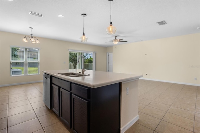 1504 Finchburg St, Minneola, FL 34715 - kitchen featuring light tile patterned floors, a ceiling fan, light countertops, hanging light fixtures, and a kitchen island with sink
