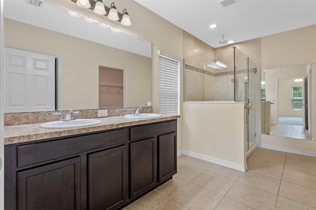 1504 Finchburg St, Minneola, FL 34715 - full bathroom featuring a shower stall, tile patterned flooring, double vanity, and a walk in closet