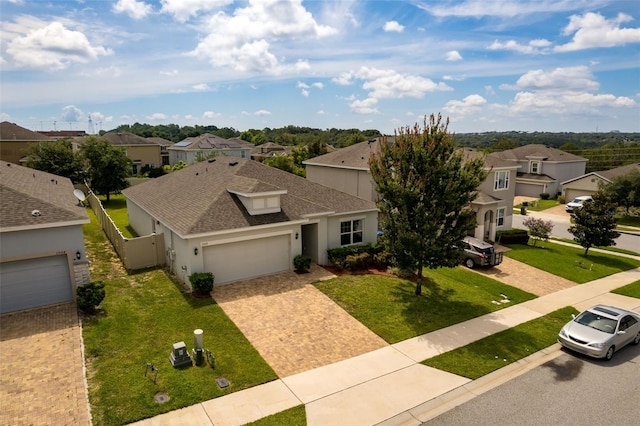 1504 Finchburg St, Minneola, FL 34715 - traditional-style home featuring a residential view, a shingled roof, a garage, stucco siding, and driveway