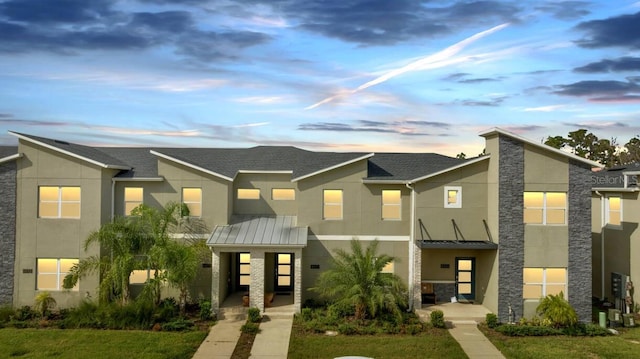 8971 Cabot Cliffs Dr, Davenport, FL 33896 - view of front of property featuring a standing seam roof, stucco siding, and a metal roof