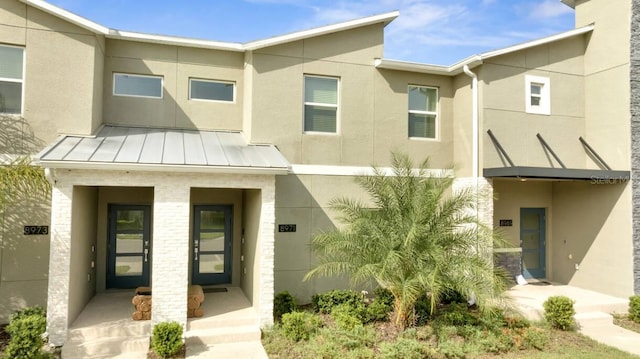 8971 Cabot Cliffs Dr, Davenport, FL 33896 - multi unit property with stucco siding, a standing seam roof, a metal roof, and a porch