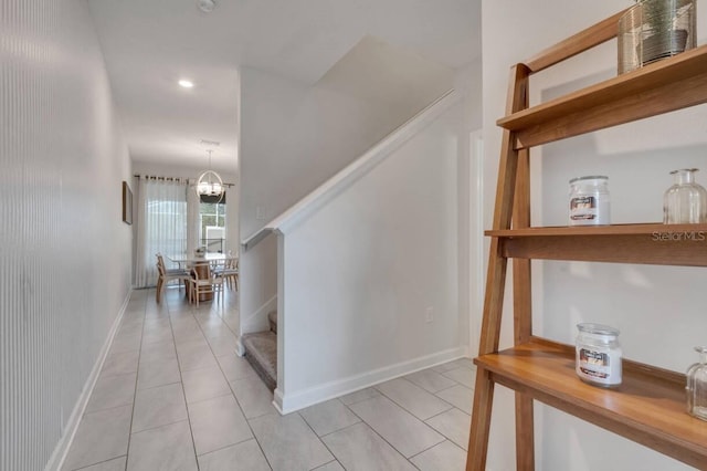 8971 Cabot Cliffs Dr, Davenport, FL 33896 - hallway with stairs, light tile patterned flooring, a chandelier, and recessed lighting