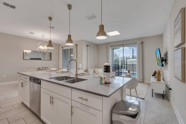 8971 Cabot Cliffs Dr, Davenport, FL 33896 - kitchen featuring dishwasher, white cabinetry, a center island with sink, and pendant lighting