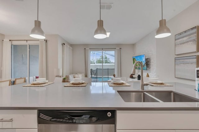 8971 Cabot Cliffs Dr, Davenport, FL 33896 - kitchen featuring stainless steel dishwasher, white cabinets, pendant lighting, and open floor plan