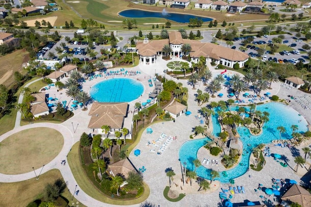 8971 Cabot Cliffs Dr, Davenport, FL 33896 - aerial perspective of suburban area with a pool area and a large body of water