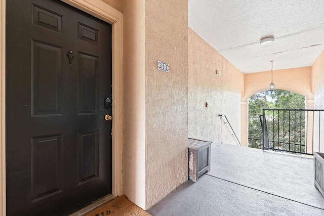5518 Metrowest Blvd Unit 11-302, Orlando, FL 32811 - view of exterior entry with stucco siding and a porch