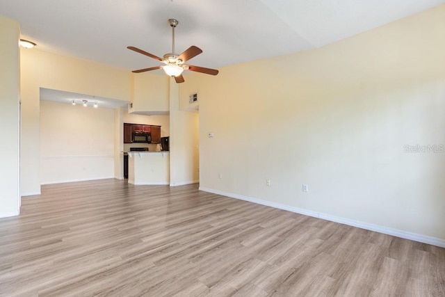 5518 Metrowest Blvd Unit 11-302, Orlando, FL 32811 - unfurnished living room with a ceiling fan, light wood finished floors, and lofted ceiling