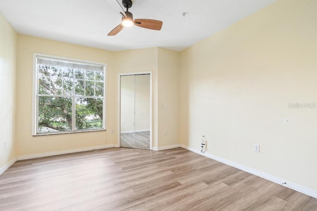 5518 Metrowest Blvd Unit 11-302, Orlando, FL 32811 - unfurnished bedroom with light wood-style floors, a closet, and ceiling fan