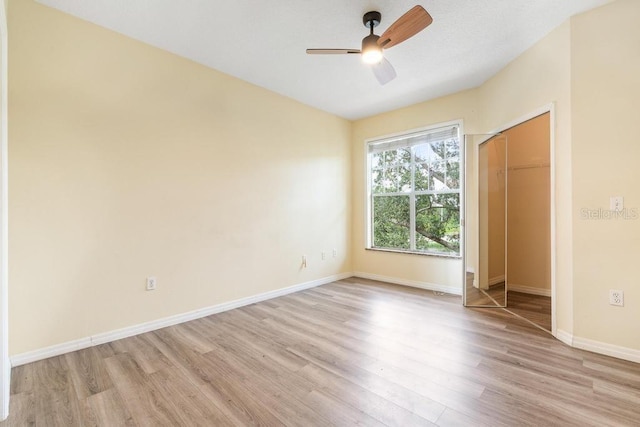 5518 Metrowest Blvd Unit 11-302, Orlando, FL 32811 - unfurnished bedroom with light wood finished floors, a closet, and a ceiling fan