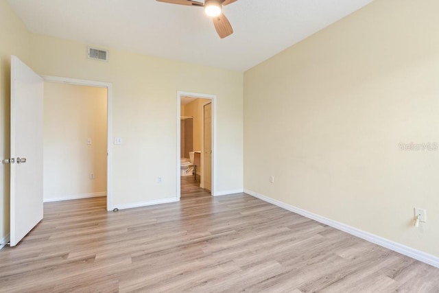5518 Metrowest Blvd Unit 11-302, Orlando, FL 32811 - unfurnished bedroom with light wood-style flooring, ensuite bathroom, and a ceiling fan