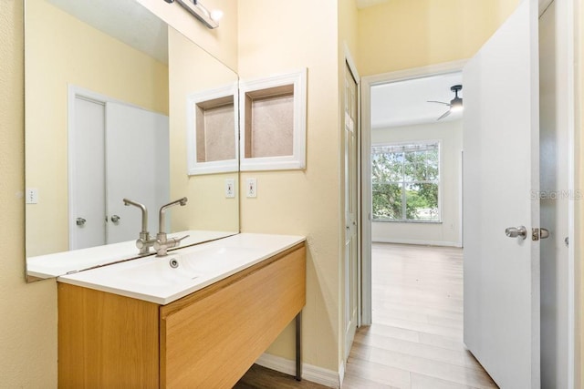 5518 Metrowest Blvd Unit 11-302, Orlando, FL 32811 - bathroom featuring vanity, wood finished floors, and a ceiling fan