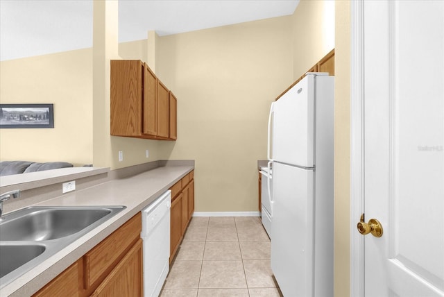 637 Harbor Villa Ct, Clermont, FL 34711 - kitchen featuring white appliances, light tile patterned floors, light countertops, and brown cabinetry