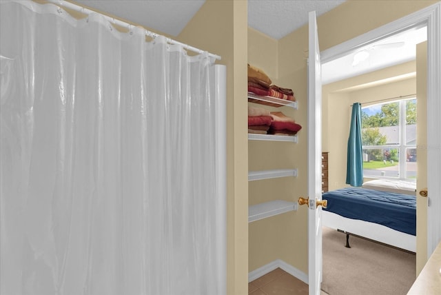 637 Harbor Villa Ct, Clermont, FL 34711 - ensuite bathroom featuring tile patterned floors and a shower with curtain