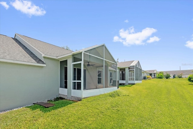 637 Harbor Villa Ct, Clermont, FL 34711 - back of house featuring a sunroom, a yard, a shingled roof, and stucco siding