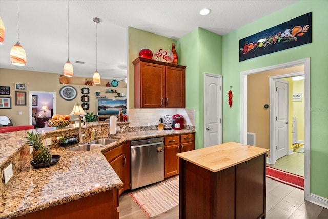 406 Benjamin Ct, Fruitland Park, FL 34731 - kitchen featuring dishwasher, light wood-style floors, hanging light fixtures, decorative backsplash, and a peninsula