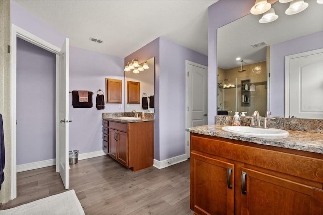 406 Benjamin Ct, Fruitland Park, FL 34731 - bathroom with a stall shower, wood finished floors, and two vanities