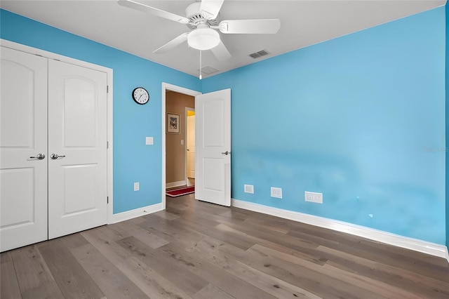 406 Benjamin Ct, Fruitland Park, FL 34731 - unfurnished bedroom featuring wood finished floors, a closet, and ceiling fan