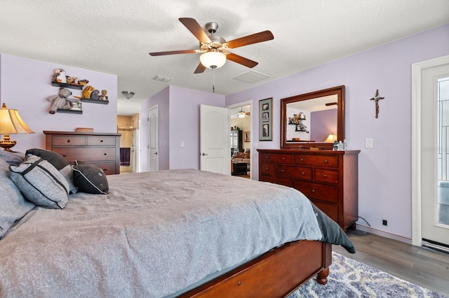 406 Benjamin Ct, Fruitland Park, FL 34731 - bedroom with wood finished floors, a ceiling fan, and connected bathroom