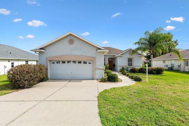 12205 SE 173rd Pl, Summerfield, FL 34491 - ranch-style home featuring stucco siding, a garage, driveway, and a front yard