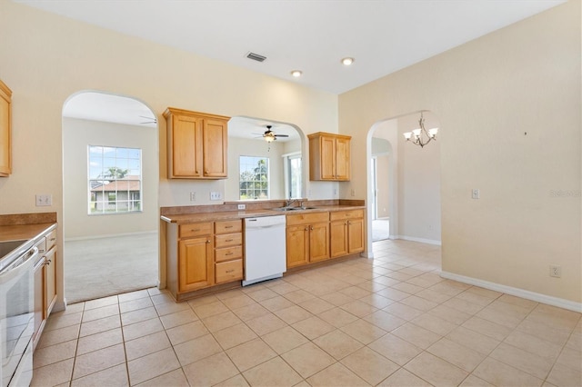 12205 SE 173rd Pl, Summerfield, FL 34491 - kitchen featuring white appliances, arched walkways, light tile patterned floors, healthy amount of natural light, and recessed lighting