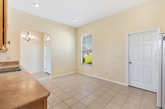 12205 SE 173rd Pl, Summerfield, FL 34491 - unfurnished dining area with a chandelier, light tile patterned floors, and arched walkways