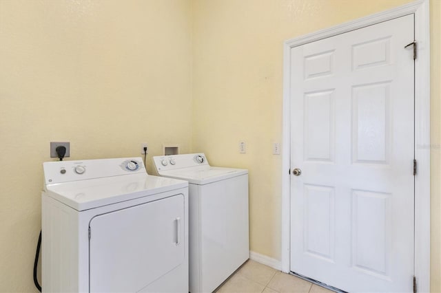 12205 SE 173rd Pl, Summerfield, FL 34491 - laundry area with washing machine and clothes dryer and light tile patterned floors