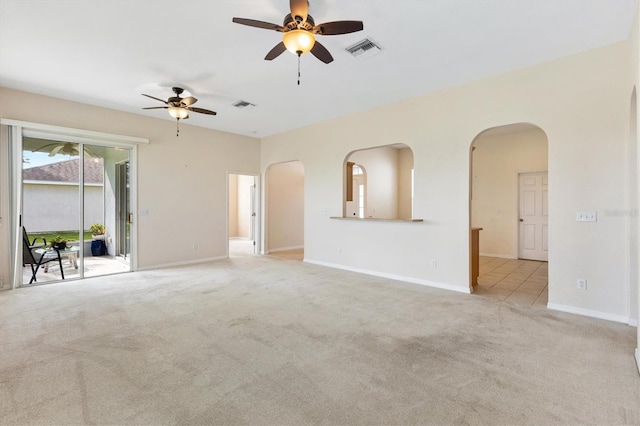 12205 SE 173rd Pl, Summerfield, FL 34491 - unfurnished living room with arched walkways, a ceiling fan, and carpet floors