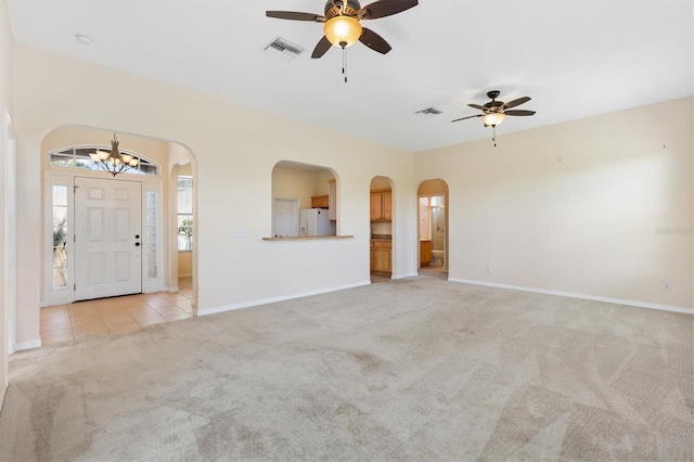12205 SE 173rd Pl, Summerfield, FL 34491 - unfurnished living room with light carpet, ceiling fan, a chandelier, and arched walkways