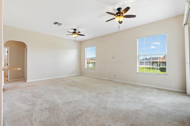 12205 SE 173rd Pl, Summerfield, FL 34491 - empty room with a ceiling fan, light carpet, and arched walkways