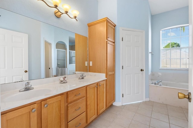 12205 SE 173rd Pl, Summerfield, FL 34491 - bathroom featuring a shower stall, a garden tub, double vanity, tile patterned flooring, and a chandelier