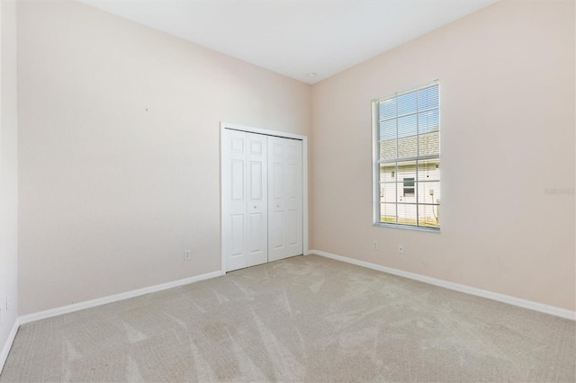 12205 SE 173rd Pl, Summerfield, FL 34491 - unfurnished bedroom featuring light carpet and a closet