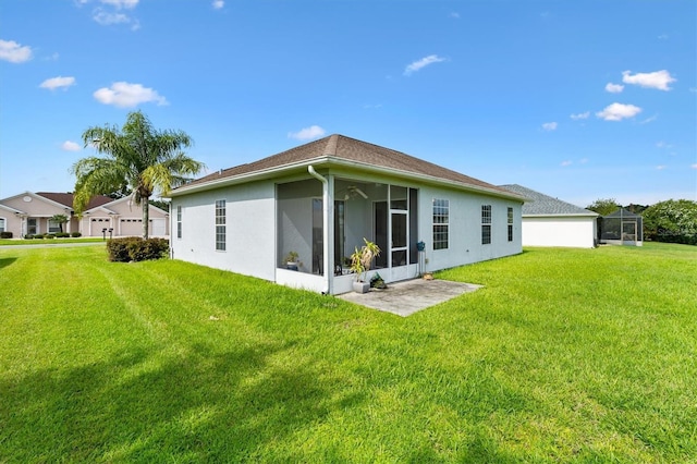12205 SE 173rd Pl, Summerfield, FL 34491 - back of house with stucco siding, a lawn, and a sunroom