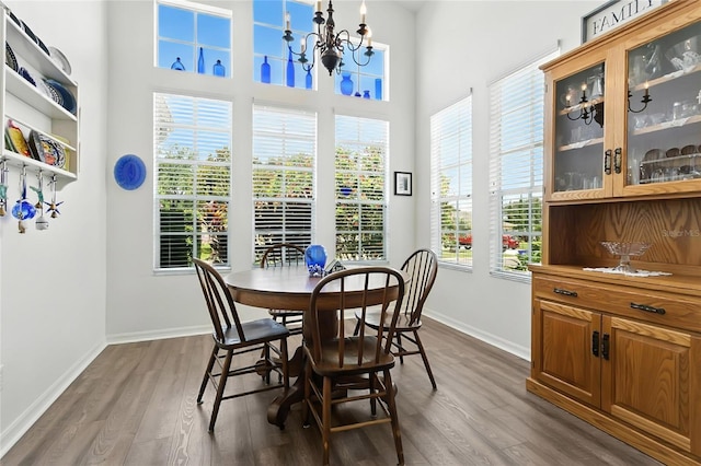 5135 Indian Ocean Loop, Tavares, FL 32778 - dining room with dark wood-style floors, a chandelier, and a towering ceiling
