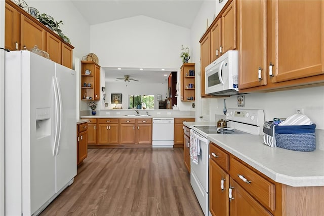 5135 Indian Ocean Loop, Tavares, FL 32778 - kitchen featuring white appliances, open shelves, vaulted ceiling, dark wood finished floors, and brown cabinetry