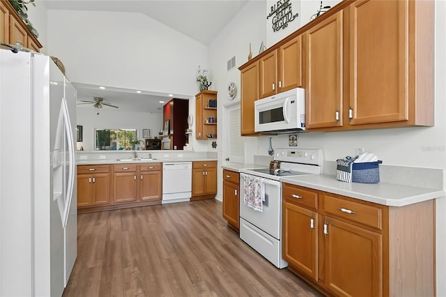 5135 Indian Ocean Loop, Tavares, FL 32778 - kitchen featuring white appliances, ceiling fan, wood finished floors, light countertops, and open shelves