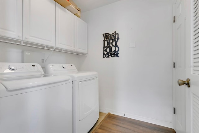 5135 Indian Ocean Loop, Tavares, FL 32778 - washroom featuring washer and clothes dryer, cabinet space, and light wood-style floors