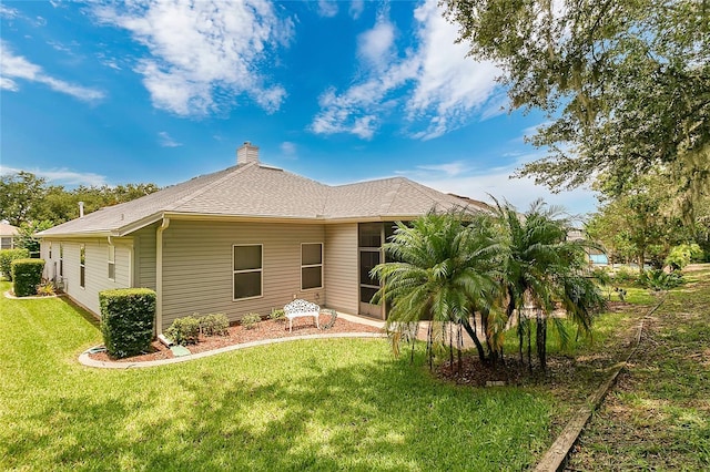 5135 Indian Ocean Loop, Tavares, FL 32778 - back of house featuring a yard and a chimney