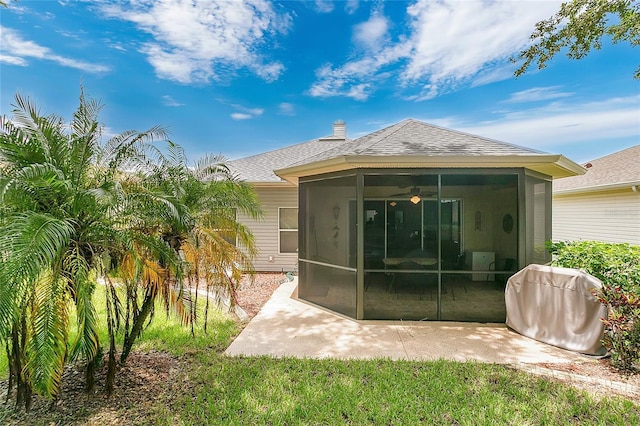 5135 Indian Ocean Loop, Tavares, FL 32778 - back of house featuring a sunroom, a patio area, a shingled roof, and a yard