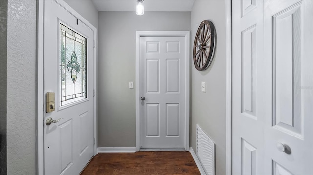 11746 Oswalt Rd, Clermont, FL 34711 - foyer entrance featuring dark wood-style floors and baseboards