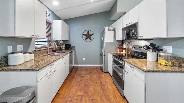 11746 Oswalt Rd, Clermont, FL 34711 - kitchen with appliances with stainless steel finishes, white cabinets, light wood finished floors, and stone counters