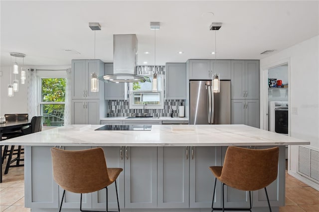 1244 Grandview Cir, Royal Palm Beach, FL 33411 - kitchen with freestanding refrigerator, island range hood, gray cabinetry, black electric stovetop, and backsplash