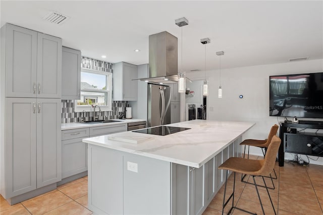 1244 Grandview Cir, Royal Palm Beach, FL 33411 - kitchen with freestanding refrigerator, gray cabinets, island exhaust hood, black electric cooktop, and a spacious island