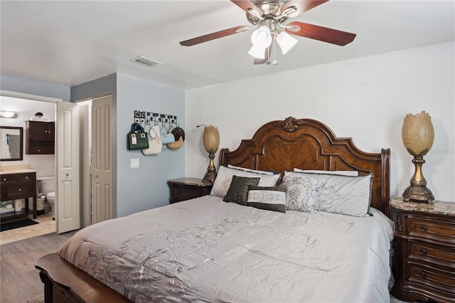 1244 Grandview Cir, Royal Palm Beach, FL 33411 - bedroom with wood finished floors, connected bathroom, and ceiling fan