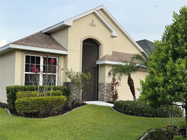 8301 Bridgeport Bay Cir, Mount Dora, FL 32757 - view of front of home featuring a shingled roof, stucco siding, a front lawn, and an attached garage